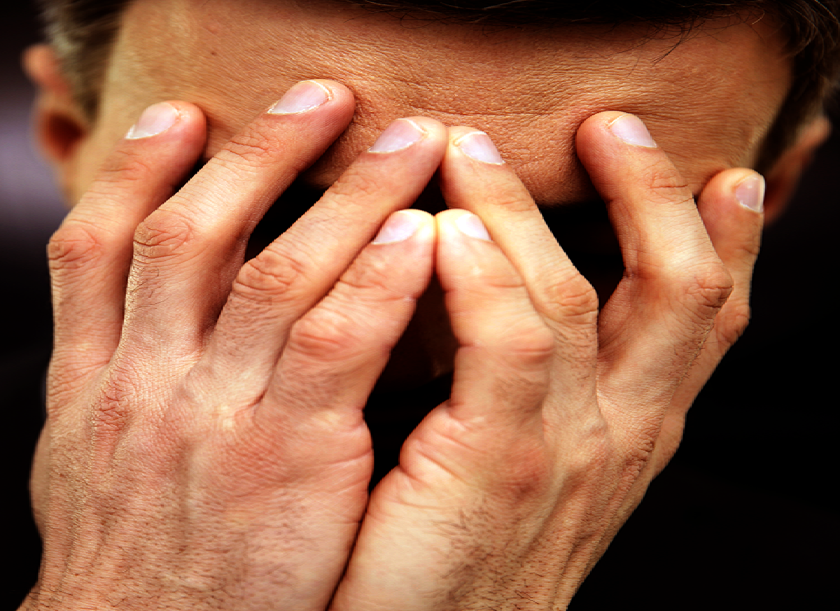 Frustrated man with hands on face